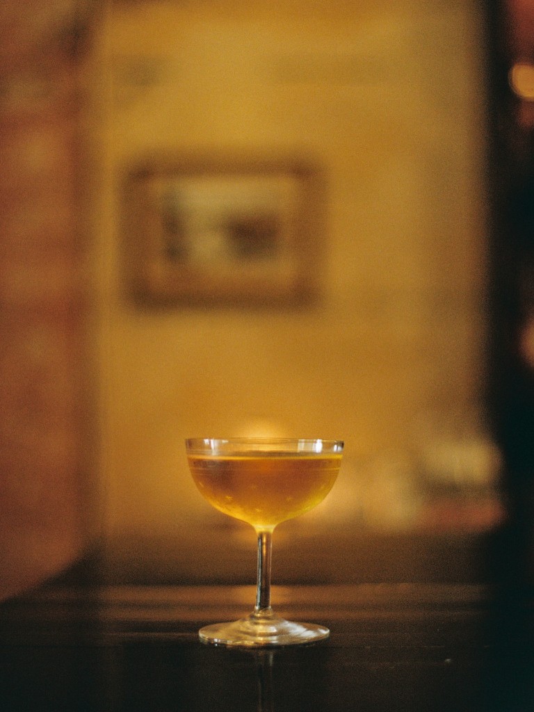 Amber cocktail in a coupe glass